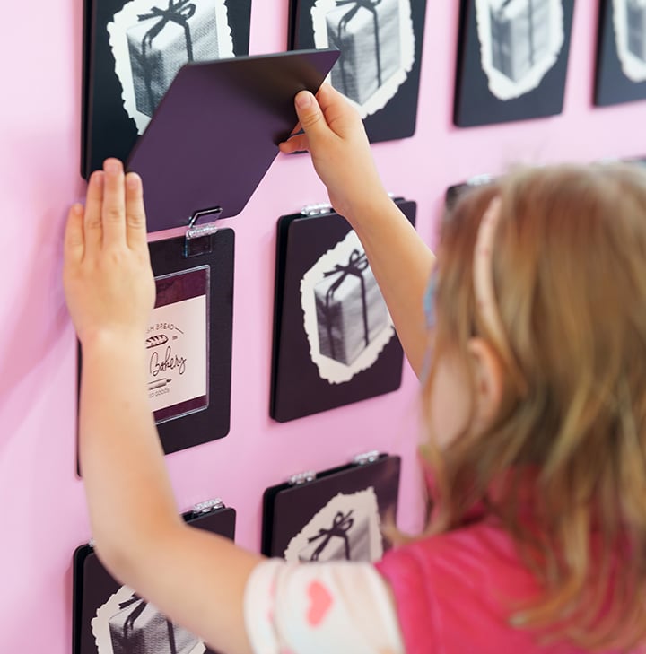 She’s wearing a pink vest and a white shirt with little pink hearts on it, which match the design of the memory game perfectly, so perfectly it’s almost like we planned it, which we totally didn’t, we swear.